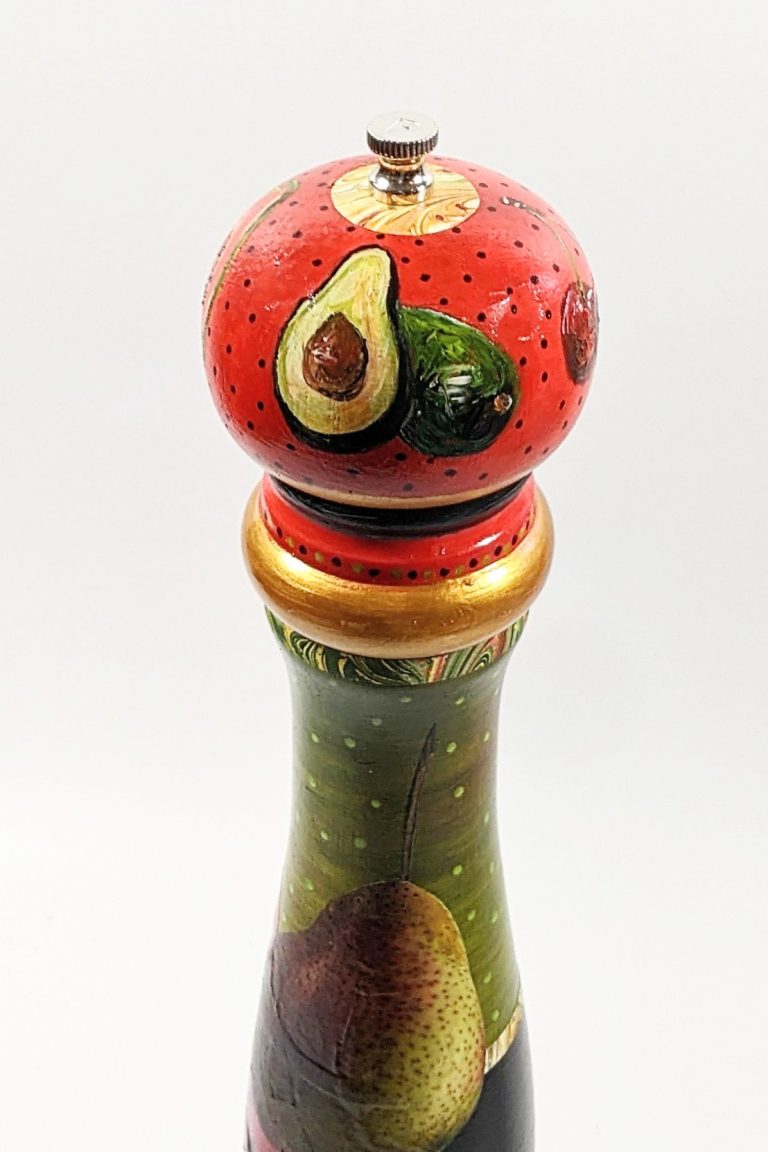 This detail shows the top of this hand-painted pepper mill of two halves of an avocado